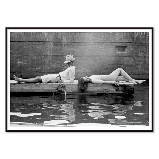 Marquess of Tavistock Henry Robin Ian Russell and Henrietta Tiarks relaxing on a dock in Bermuda by Toni Frissell poster, with black aluminium frame on white background