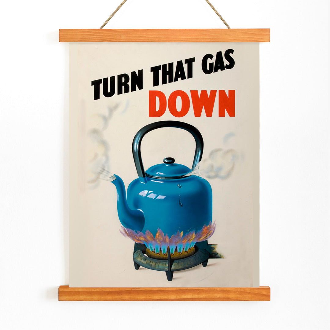 Blue kettle boiling on gas stove with steam and flames promoting energy saving from Turn that gas down artwork, with wooden magnetic frame on white background