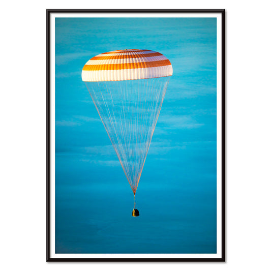 Soyuz TMA-14M spacecraft descending with parachute against blue sky NASA Expedition 42 landing poster artwork, with black aluminium frame on white background