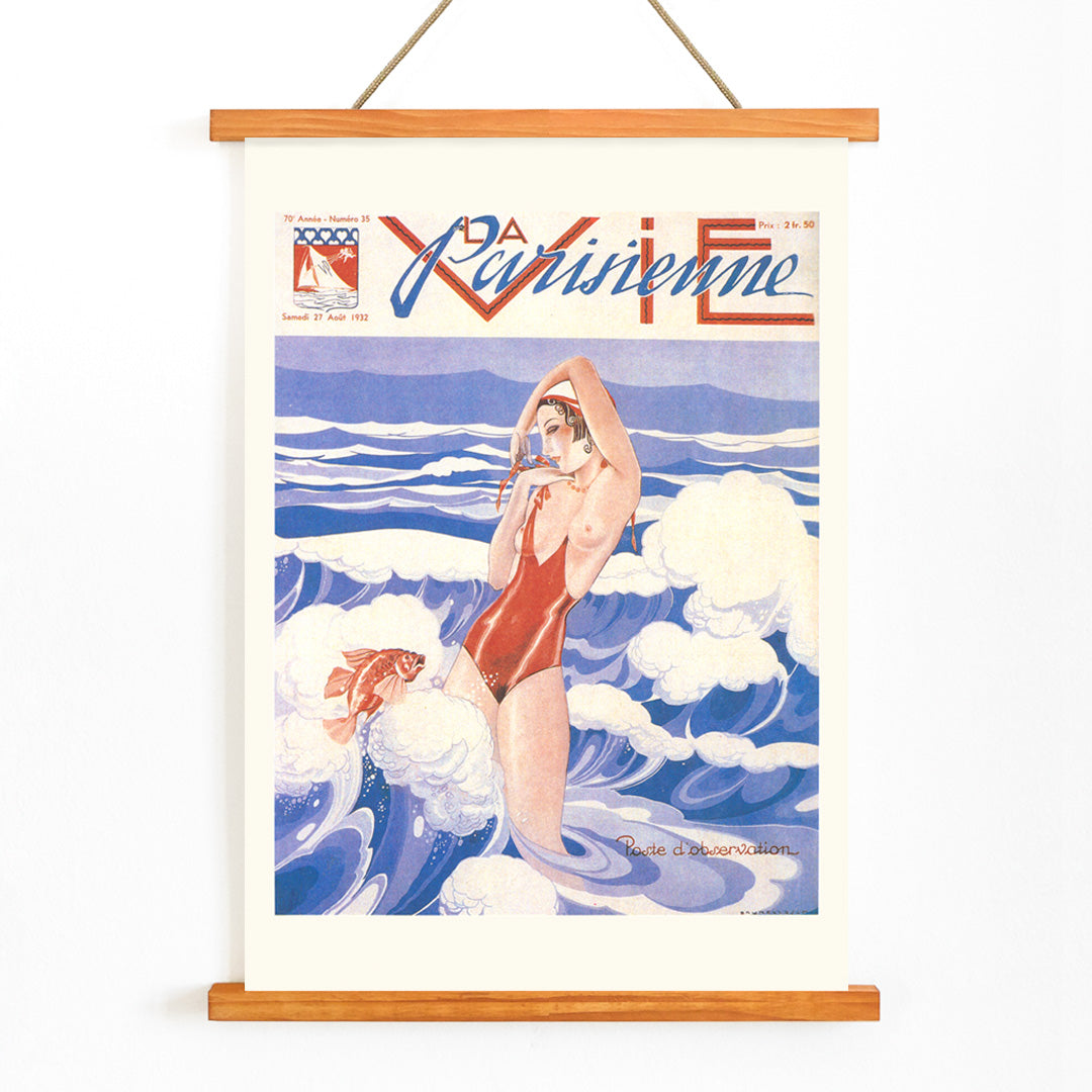 Art Deco poster of La Vie Parisienne by Umberto Brunelleschi showing a woman in a red swimsuit standing in ocean waves with a fish, with wooden magnetic frame on white background