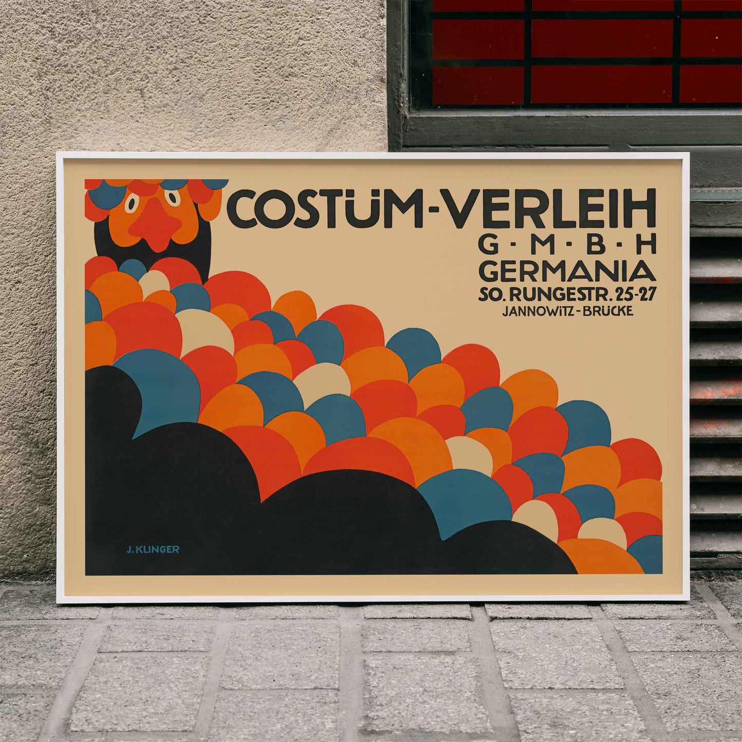 Poster by Julius Klinger for Costüm-Verleih Germania with red blue orange and black abstract circles and bold typography, framed and displayed in home decor