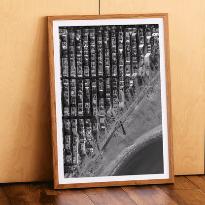 Aerial cityscape and black and white poster of Barceloneta beach and city grid aerial view, framed and displayed in home decor