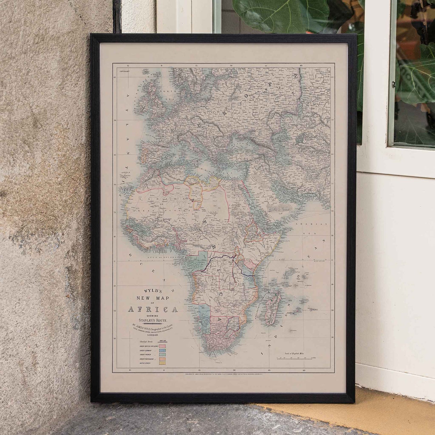 Wyld New Map of Africa vintage cartographic poster in beige grey blue and red tones, framed and displayed in home decor