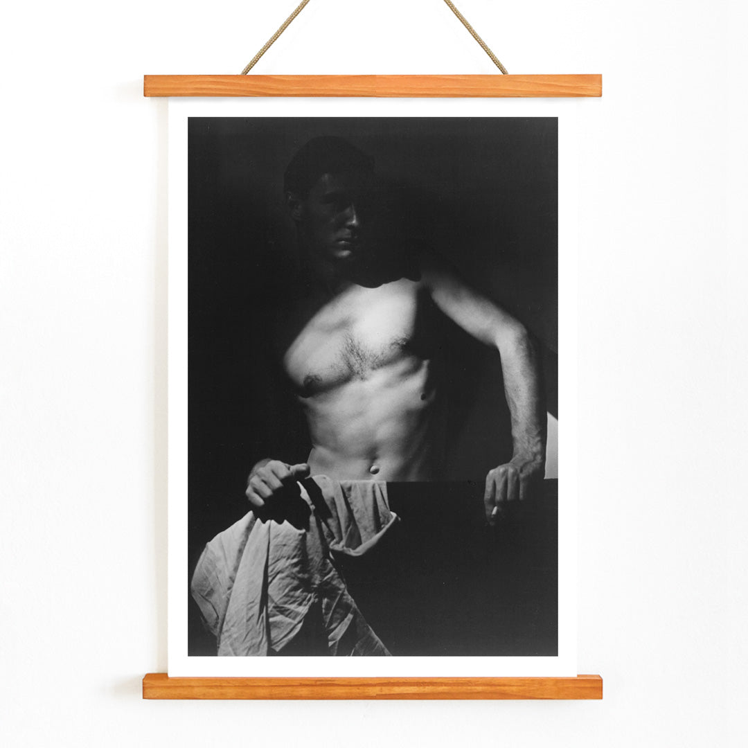 Shirtless man holding towel in dramatic lighting Max After Surfing by Olive Cotton wall art photography poster, with wooden magnetic frame on white background