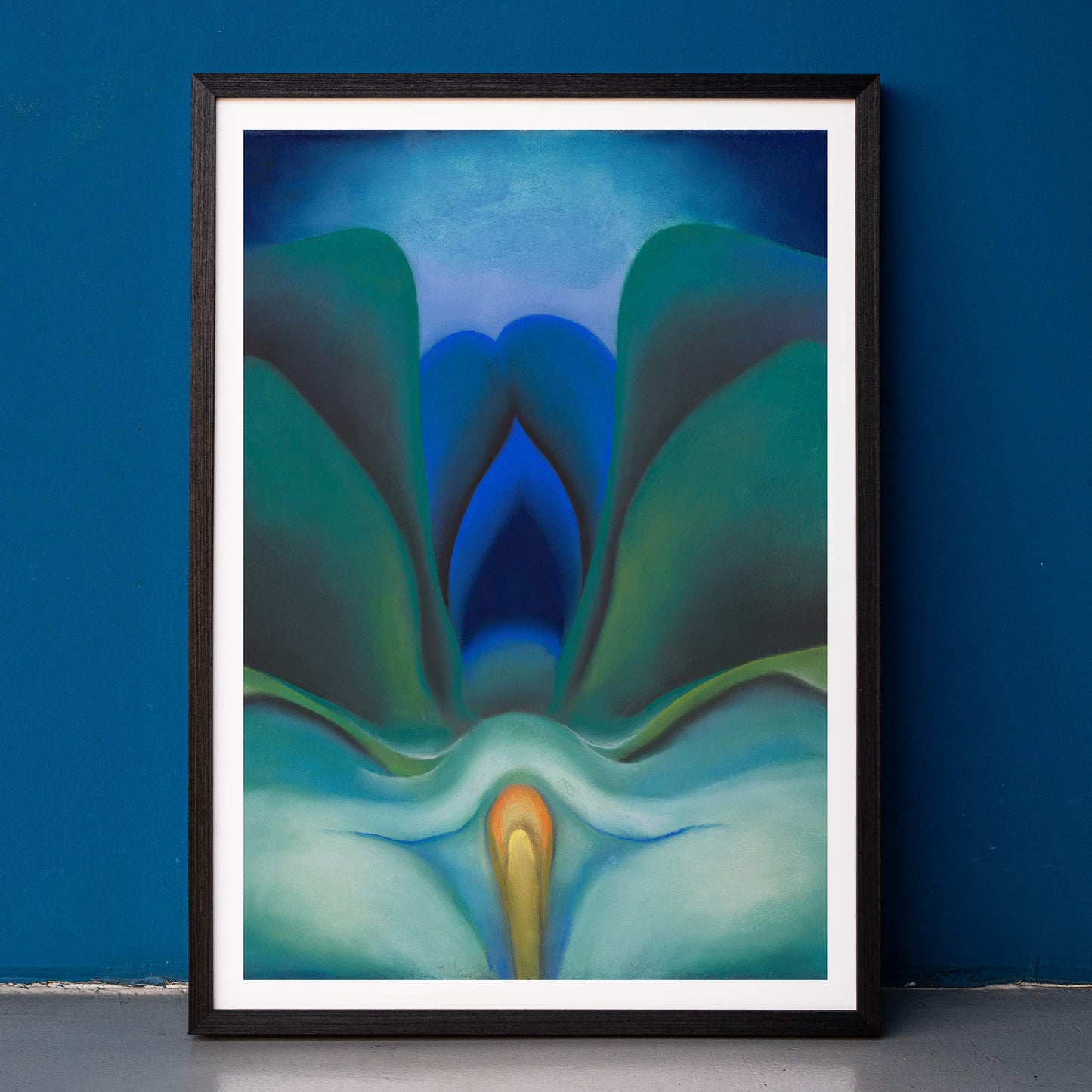 Georgia OKeeffe Blue Flower poster luminous blue and green abstract bloom with soft yellow center, framed and displayed in home decor