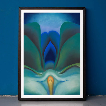 Georgia OKeeffe Blue Flower poster luminous blue and green abstract bloom with soft yellow center, framed and displayed in home decor
