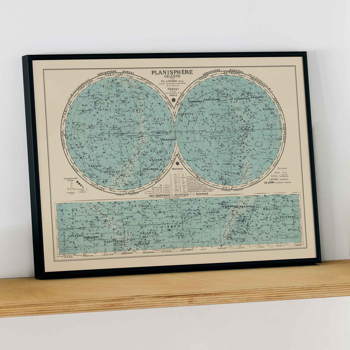 Joseph Forest Celestial planisphere poster with twin star hemispheres, constellation markings, and vintage teal scientific map, framed and displayed in modern living room decor