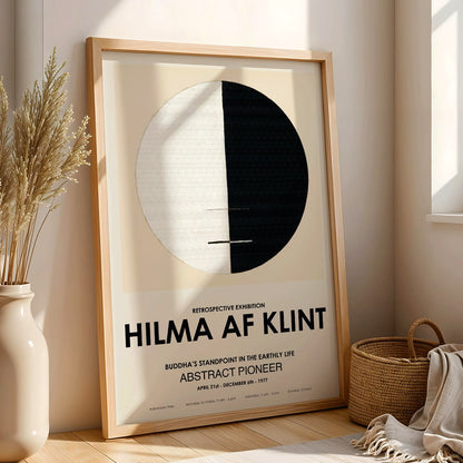 Exhibition poster Buddhas Standpoint in the Earthly Life by Hilma Af Klint featuring abstract black and white circle design artwork, framed and displayed in modern living room decor