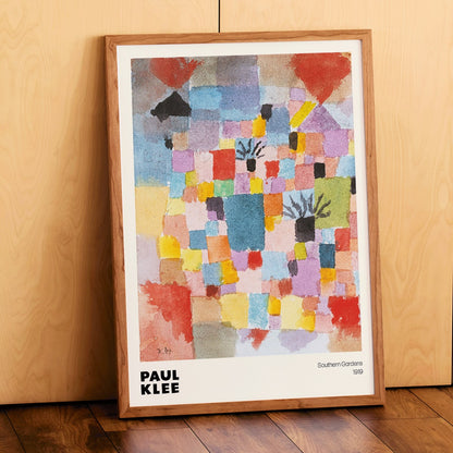 Colorful abstract painting Southern Gardens by Paul Klee featuring vibrant geometric blocks and shapes poster artwork, framed and displayed in modern living room decor