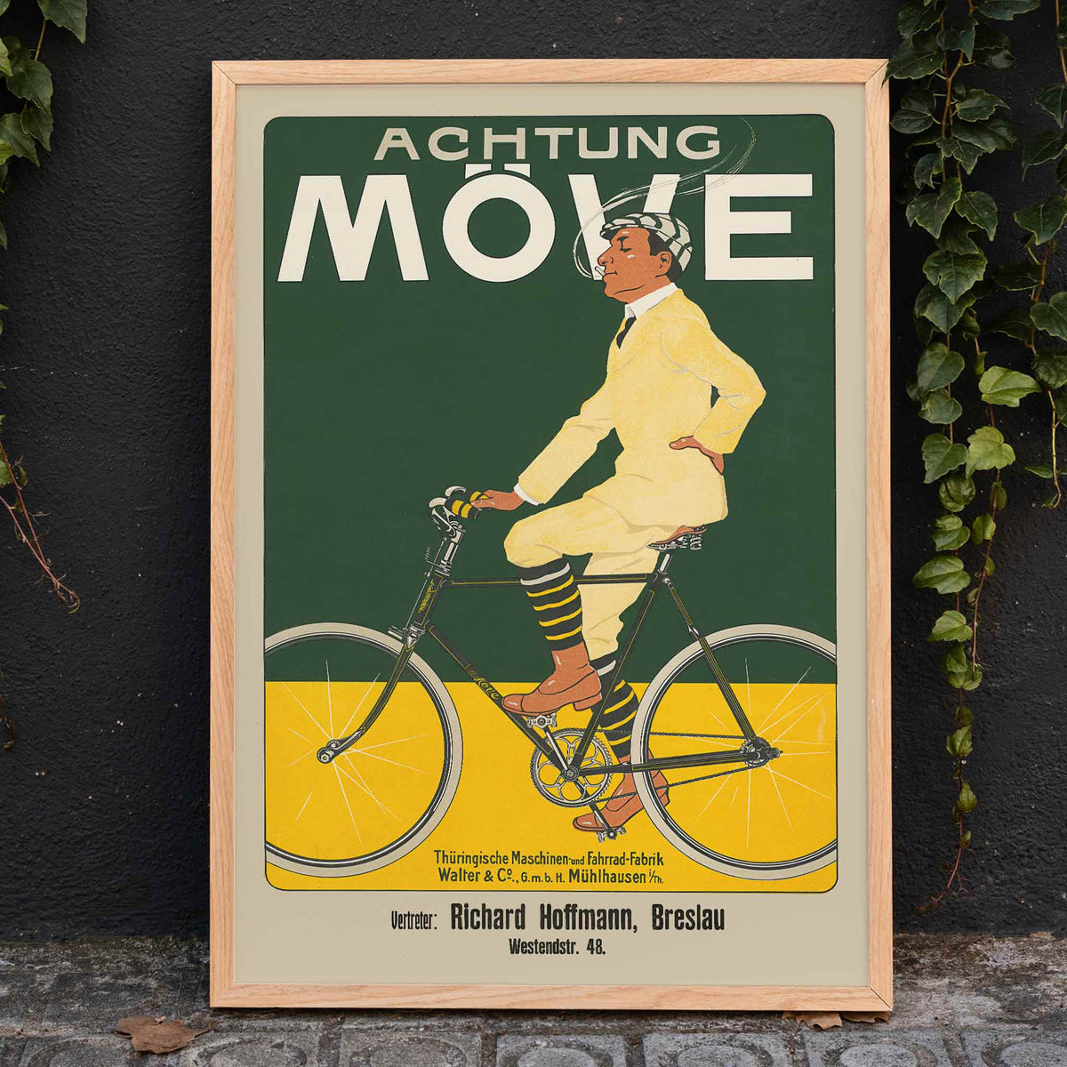 Achtung Moeve poster by J. and Co. Aberle featuring a cream cyclist on a vintage bicycle against a green and yellow cycling scene, framed and displayed in home decor