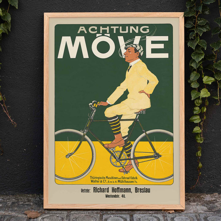 Achtung Moeve poster by J. and Co. Aberle featuring a cream cyclist on a vintage bicycle against a green and yellow cycling scene, framed and displayed in home decor