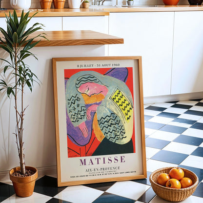 Henri Matisse The Dream exhibition poster at Aix en Provence featuring colorful abstract design with reclining figure, framed and displayed in modern living room decor