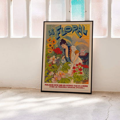 Le Floral poster featuring a woman tending and watering vibrant colorful flowers with bold Le Floral text in the background, framed and displayed in modern living room decor