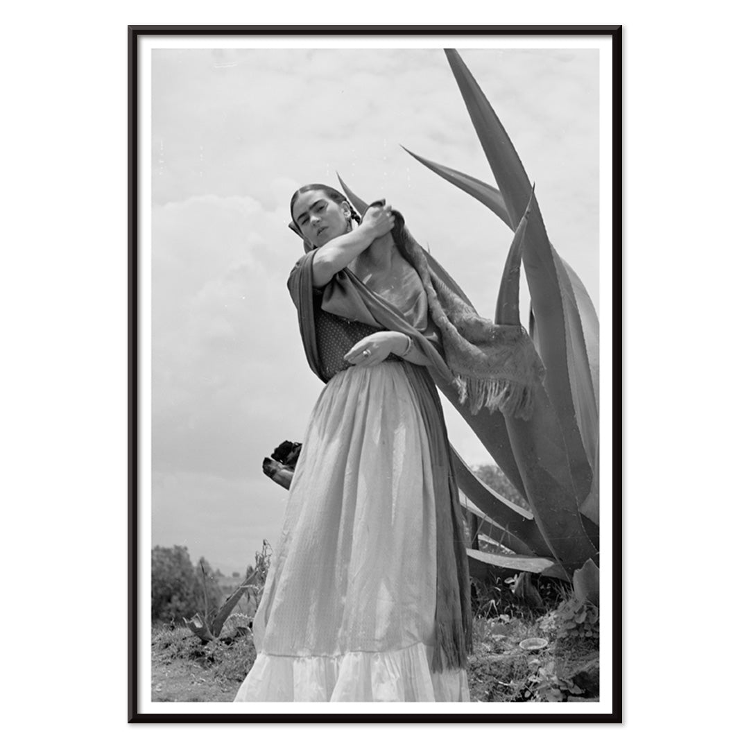 Frida Kahlo Senora Diego Rivera standing beside agave plant by Toni Frissell black and white artwork poster, with black aluminium frame on white background
