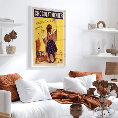 Chocolat Menier poster by Firmin Bouisset featuring a young girl writing on a yellow wall with a basket of chocolate and an umbrella, framed and displayed in home decor