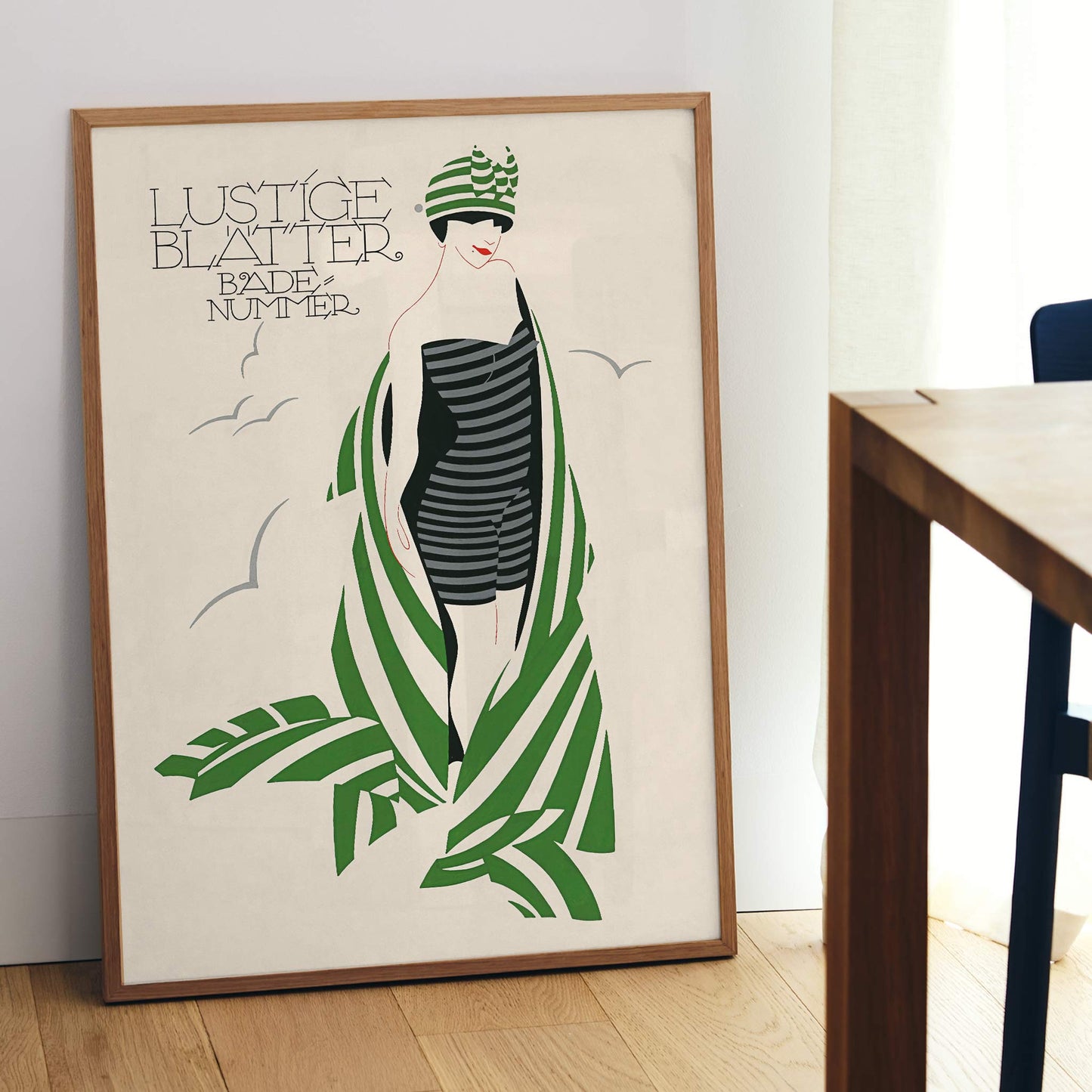 Julius Klinger Lustige Blatter Badenummer poster with stylized woman in striped swimsuit, green palm leaves, cream background, framed and displayed in modern living room decor