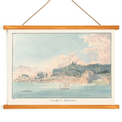 Seaside village and coastal landscape painting with sailboats and forested hill titled Friendly Cove Nootka Sound by Charles Hamilton Smith, with wooden magnetic frame on white background