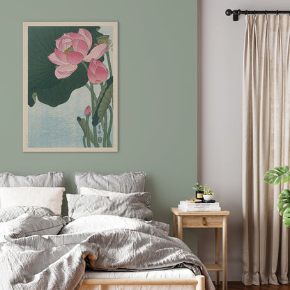 Pink lotus flowers and green leaves in Japanese woodblock print poster by Ohara Koson with light blue background, framed and displayed in home decor