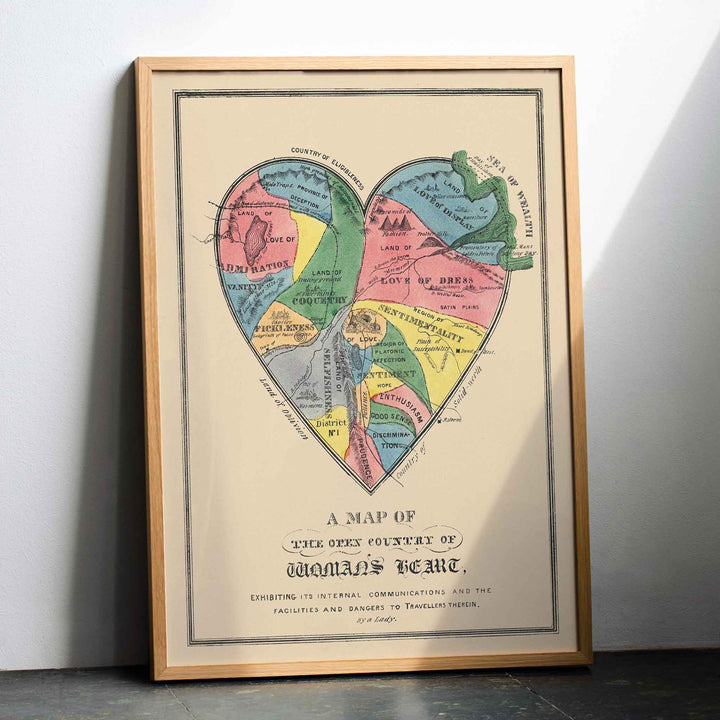Open Country of Womans Heart poster by E.B. and E.C. Kellogg, colorful heart shaped map with labeled regions, vintage cartographic style, with wooden magnetic frame on white background