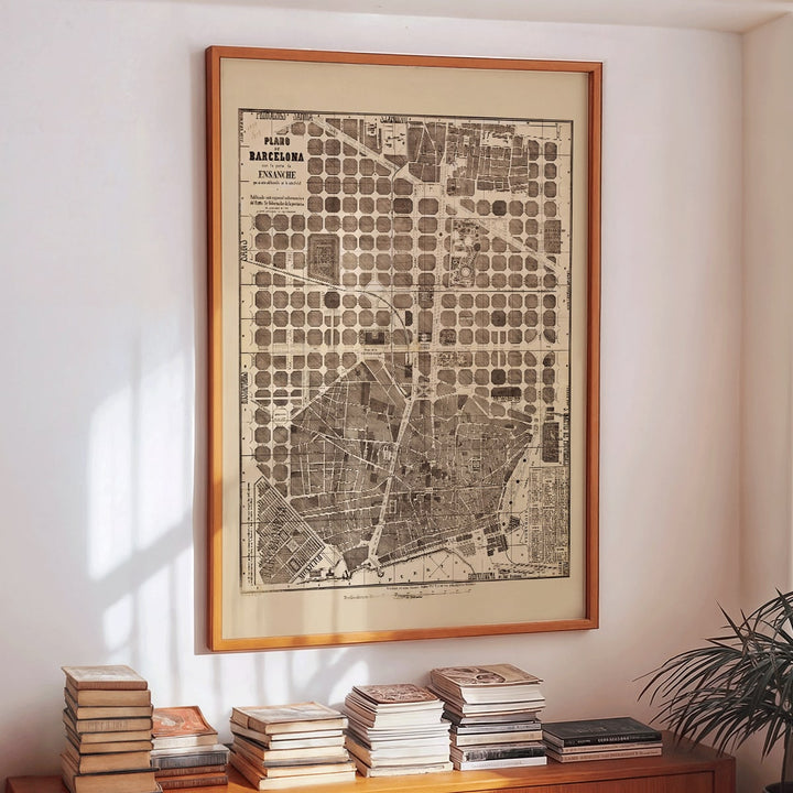 Detailed vintage map of Barcelona poster artwork featuring a city map layout with illustrated streets and blocks, framed and displayed in modern living room decor