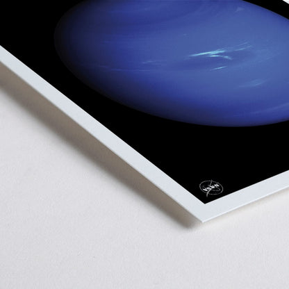 Closeup detail of NASA poster of Neptune showing a detailed blue planet against a black background with the title Neptune at the bottom