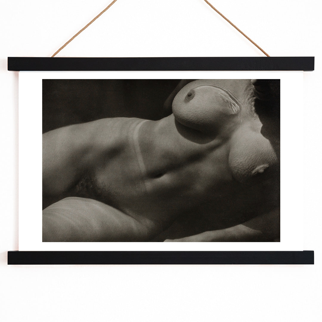 Black and white artistic photograph of reclining nude female torso Rebecca Salsbury Strand by Alfred Stieglitz, with wooden magnetic frame on white background