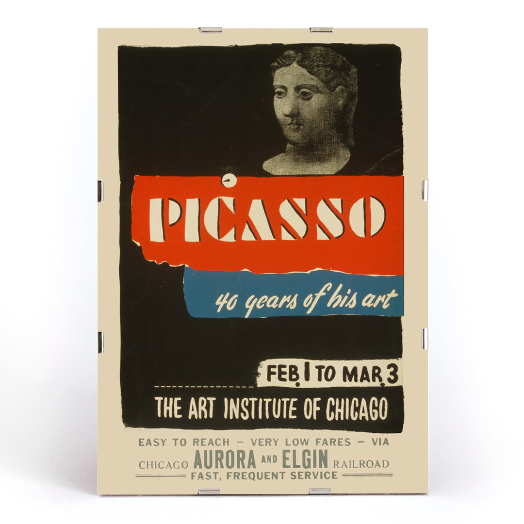 Vintage exhibition poster for Picasso 40 years of his art at Art Institute of Chicago featuring classical sculpture bold graphic text and sculpted head artwork, framed and displayed in modern living room decor
