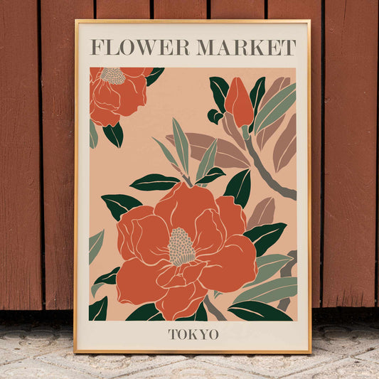 Flower Market Tokyo poster by Moryarty with vibrant orange and large red flowers green leaves and bold text on beige background, framed and displayed in home decor