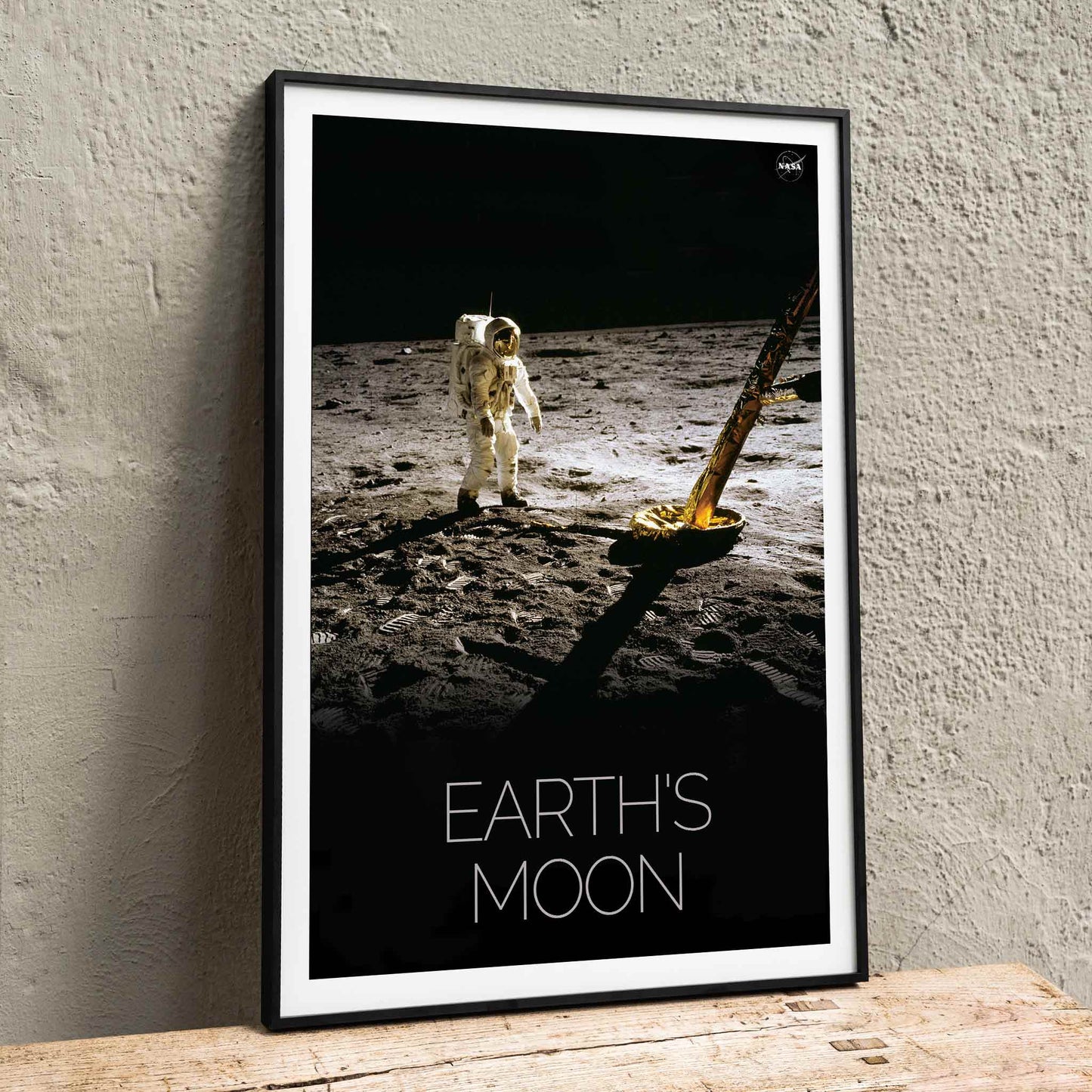 Astronaut on the lunar surface with text Earths Moon Man on Moon 2 by NASA poster, framed and displayed in home decor