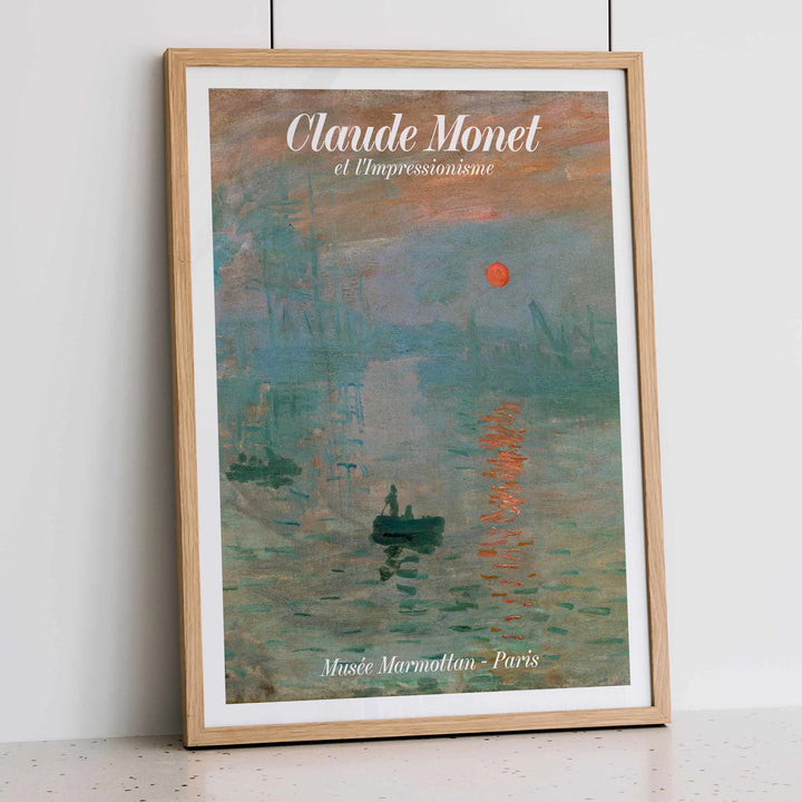 Claude Monet Soleil Levan exhibition poster vibrant impressionist artwork with red sun over water, framed and displayed in modern living room decor