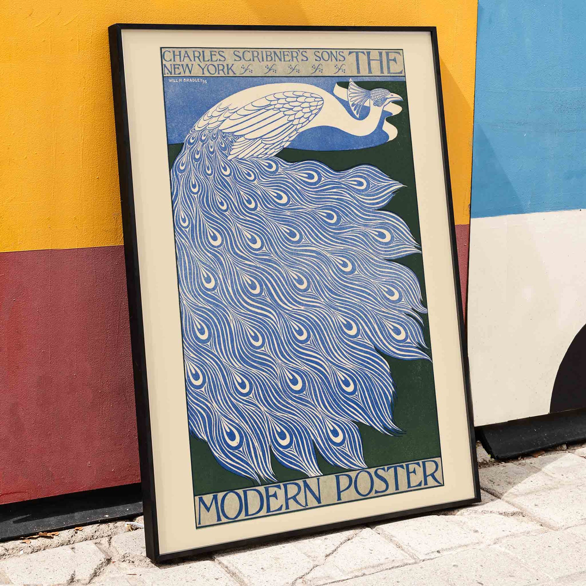 Elegant blue and white peacock with flowing feathers illustration from The Modern Poster by Will Bradley, framed and displayed in home decor