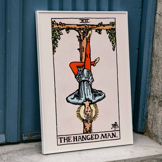 Hanged Man Tarot Card by Rider Waite, figure hanging upside down from wooden structure, mystical poster art, framed and displayed in home decor