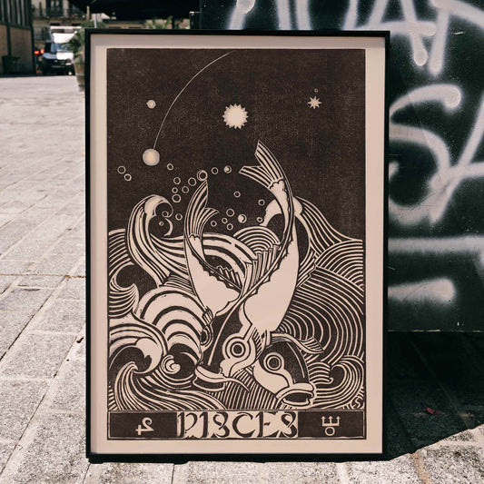 Black and white Pisces zodiac sign illustration with two stylized fish swimming among swirling waves artwork by Henri van der Stok, framed and displayed in home decor