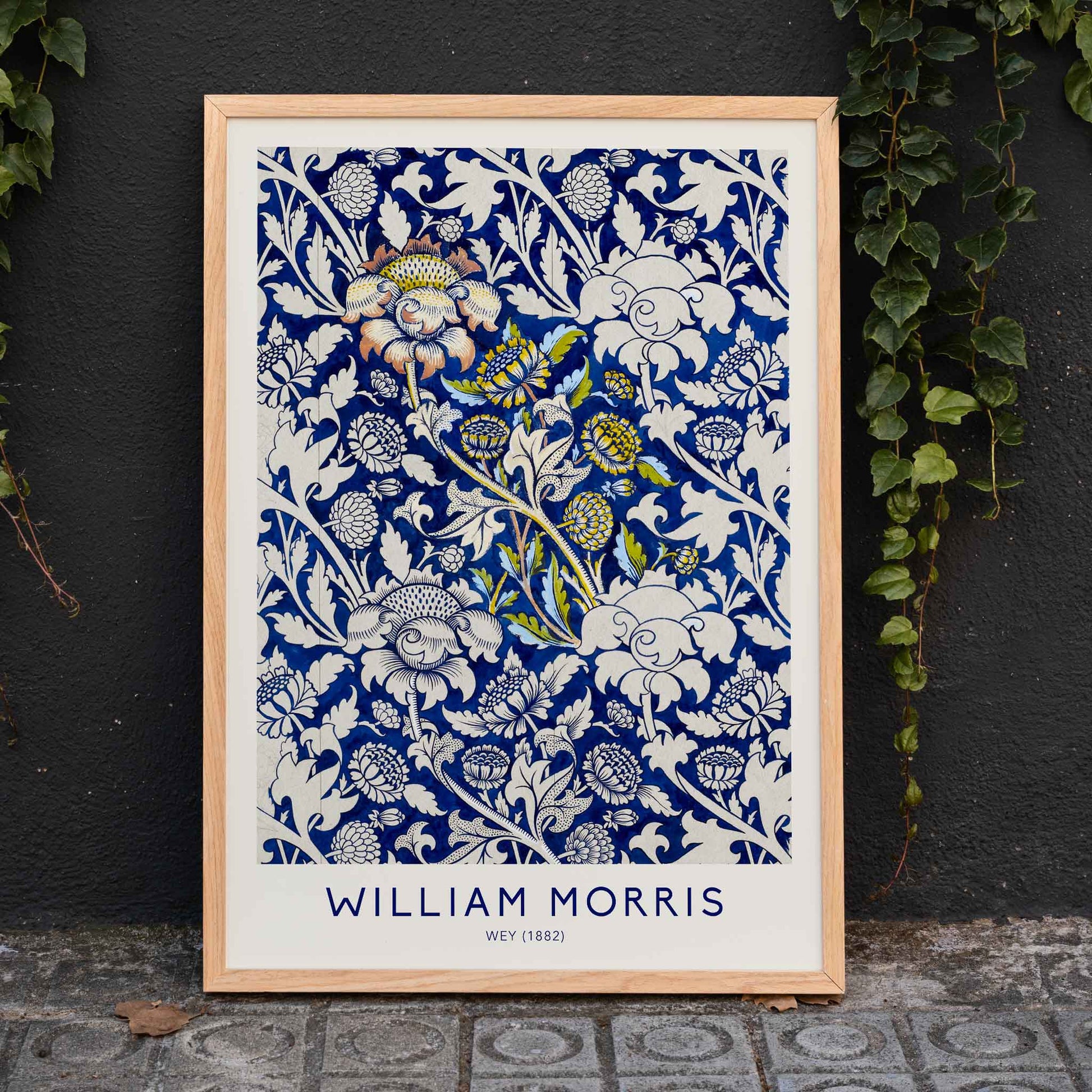 Floral fabric pattern and watercolour poster with intricate blue and white design by William Morris Wey, framed and displayed in home decor