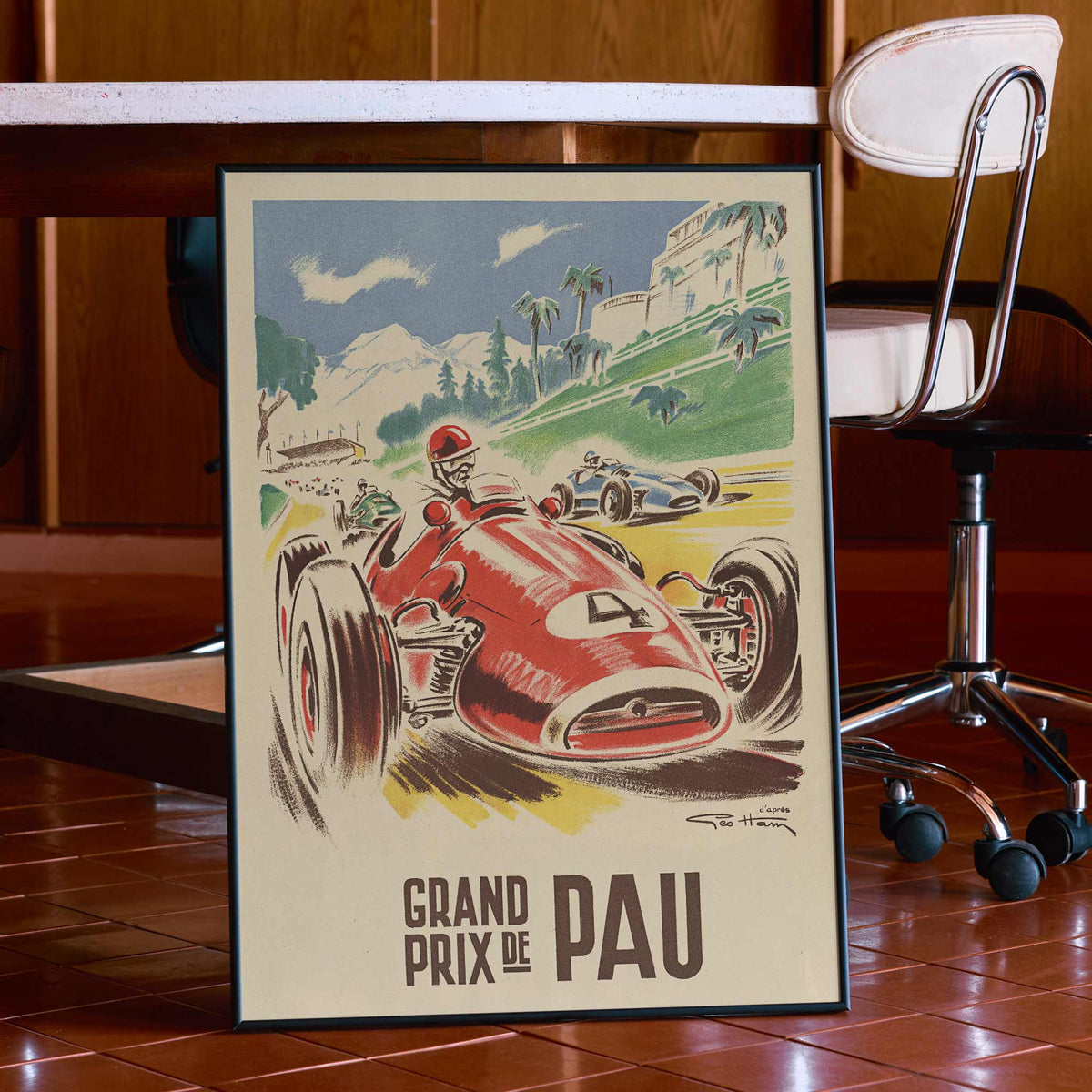 Georges Hamel Grand Prix de Pau poster with red racing car on a sunlit circuit near green hills and mountain castle, with wooden magnetic frame on white background