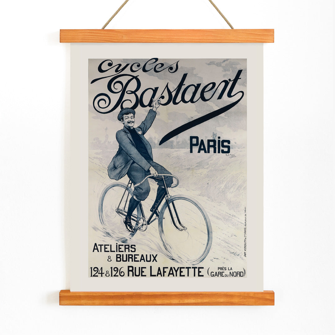 Vintage bicycle poster joyful man riding and waving on Cycles Bastaent Paris bike artwork by Charles Tichon, with wooden magnetic frame on white background