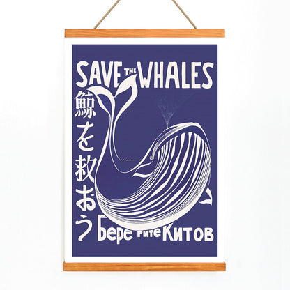 Save the Whales poster by Lawrence Vint featuring a stylized white whale and multilingual save the whales message on blue background, with wooden magnetic frame on white background