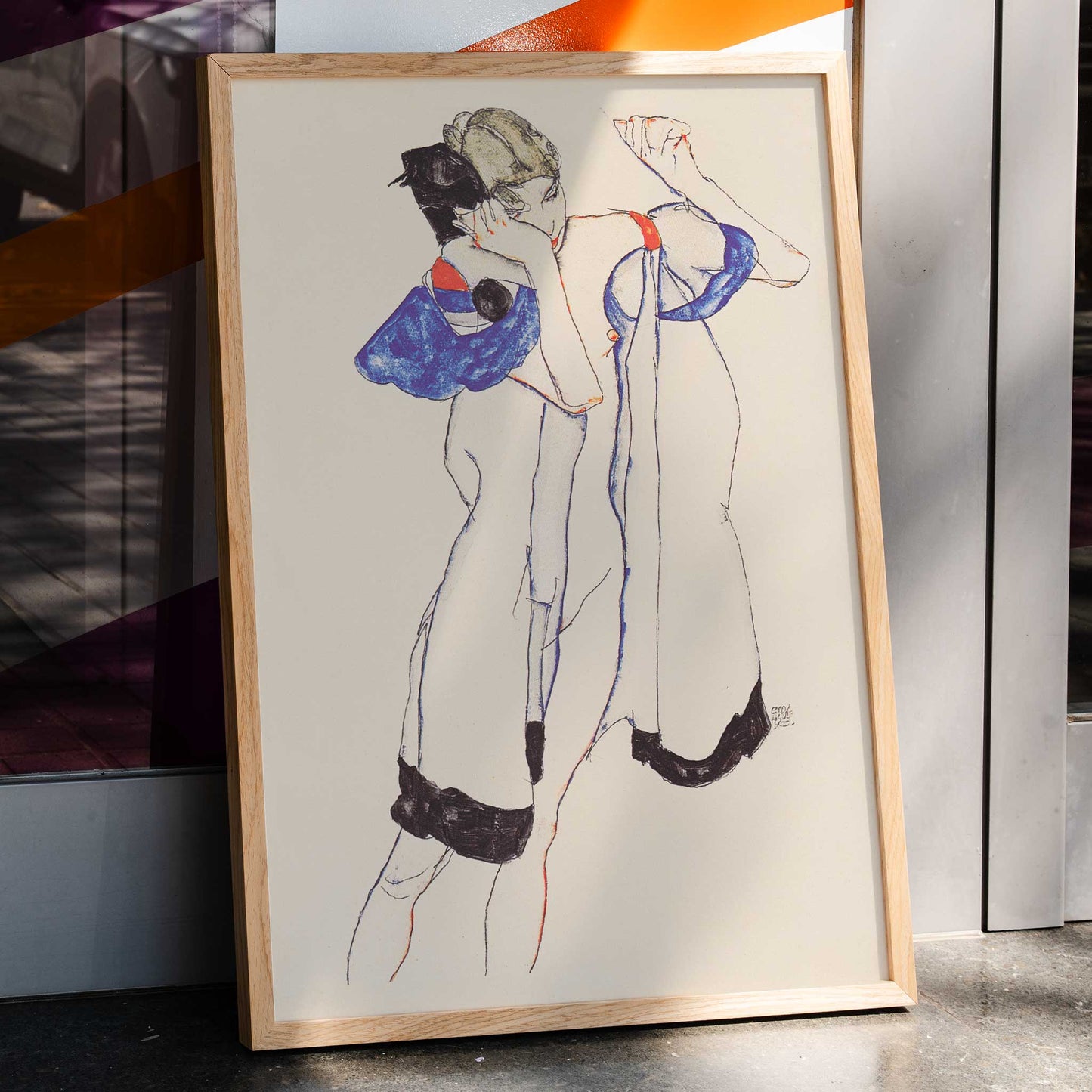 Egon Schiele Woman in a Morning Robe poster with delicate expressionist figure in white blue and black on beige background, framed and displayed in home decor