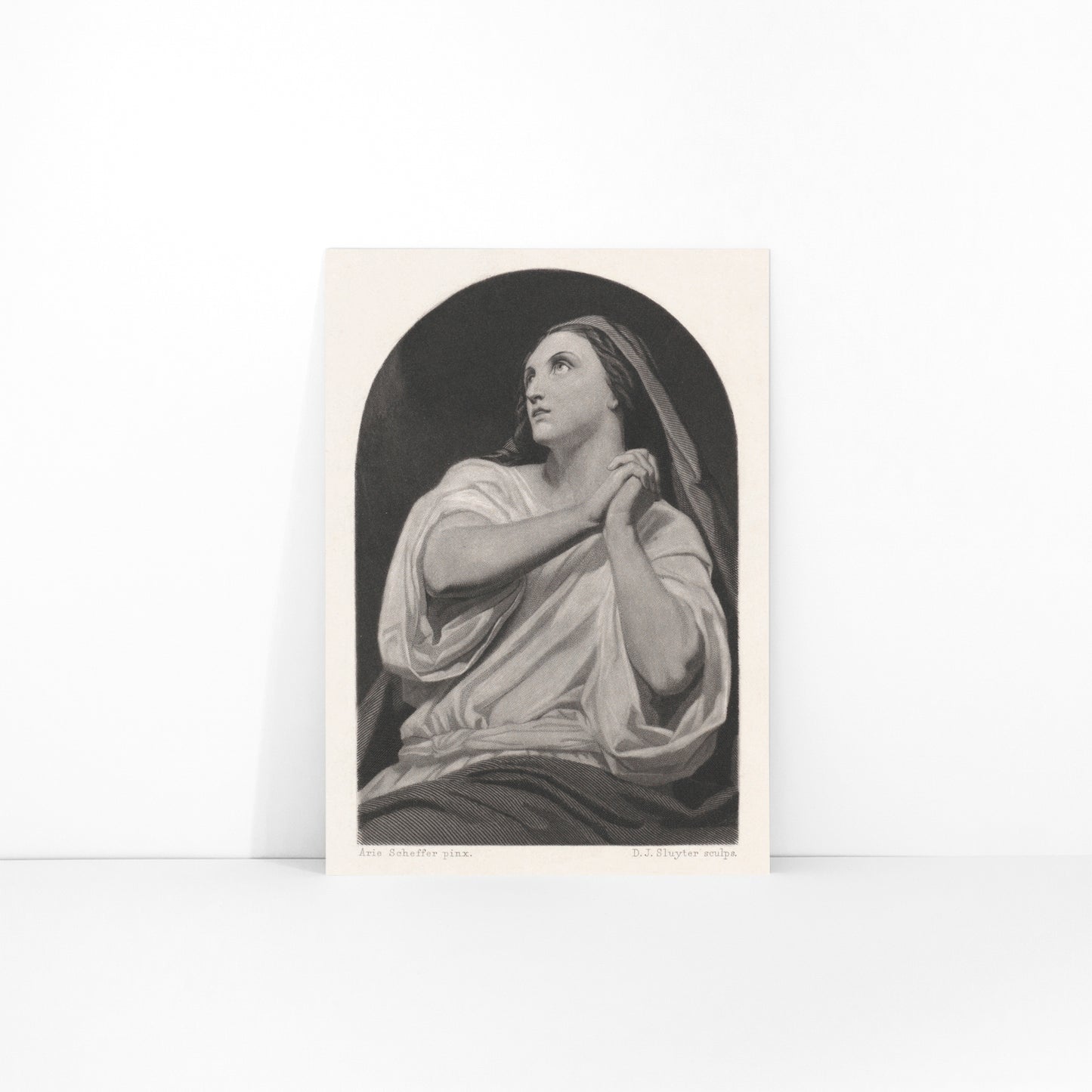 Black and white artwork of a praying woman with folded hands and serene expression by Dirk Jurriaan Sluyter, framed and displayed in modern living room decor